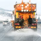 A truck is spreading De-icing salt on road