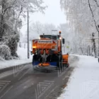 A truck is spreading De-icing salt on road