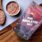 Himalayanbays's Pink Himalayan rock salt pouch with a bowl and spoon full of pink salt grains