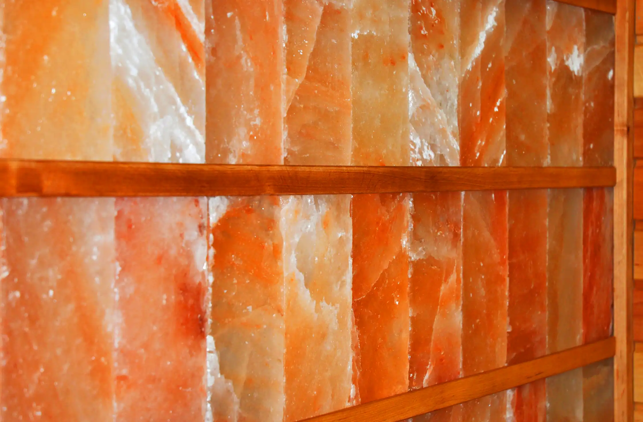 Close-up view of a Himalayan salt wall built using the dry stack method, showcasing the natural beauty and interlocking pattern of the individual salt bricks.