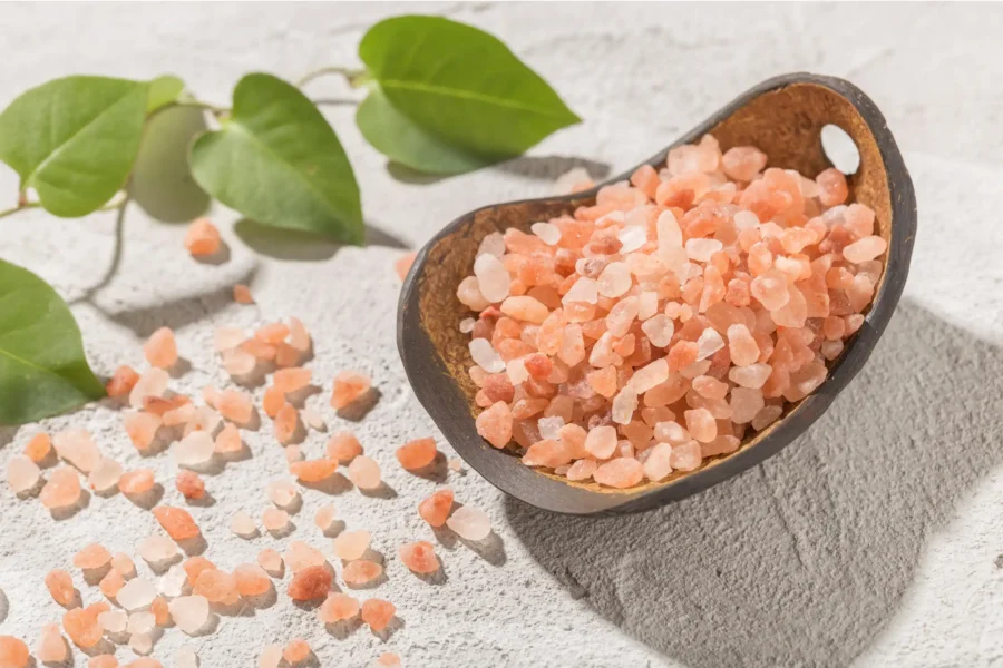 Pink Himalayan coarse grain salt in coconut bowl