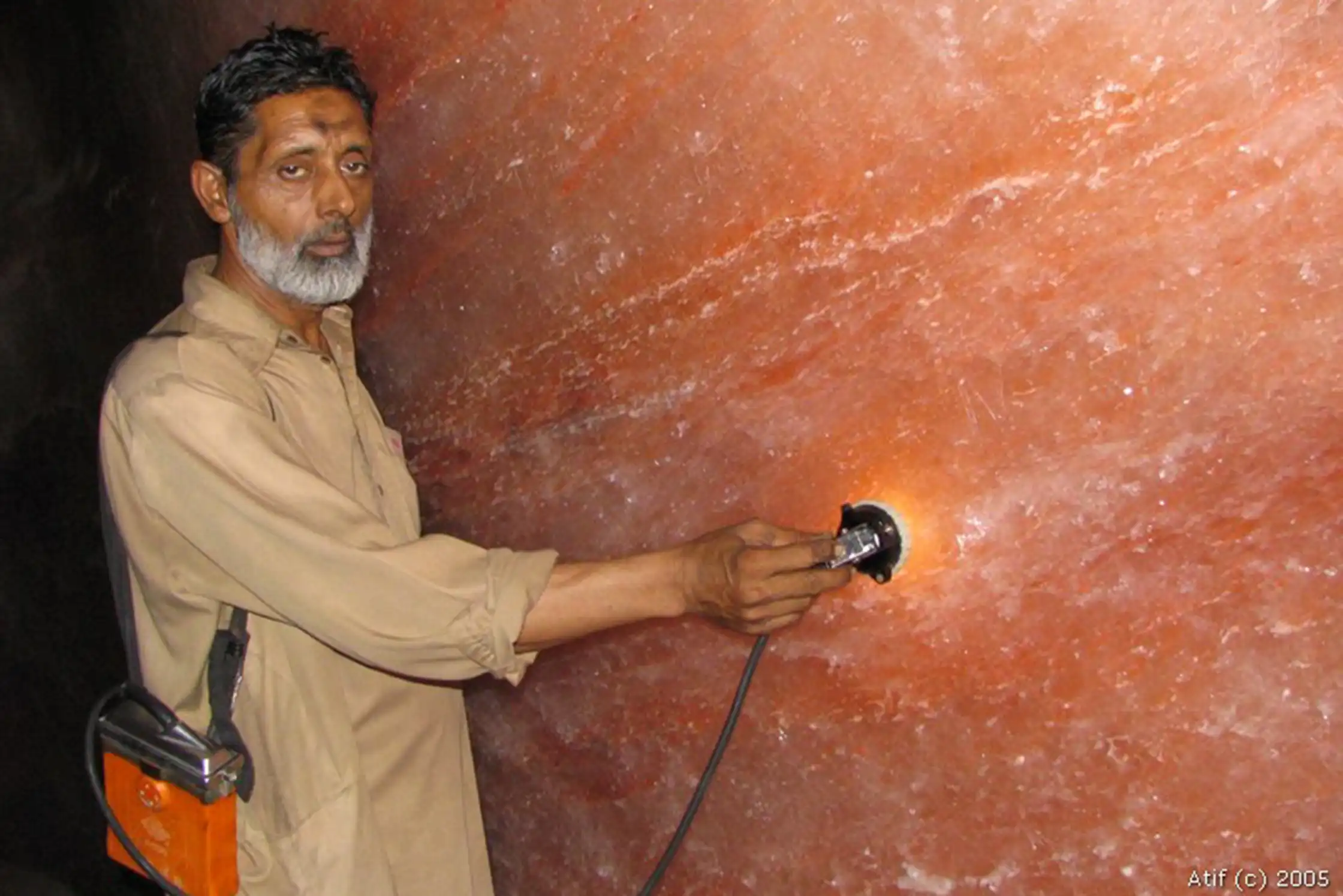 A man is testing himalayan salt quality in himalayan salt mine